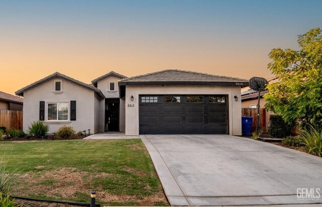 8414 Kowa St, Bakersfield, CA 93314 - ranch-style house featuring driveway, an attached garage, and stucco siding