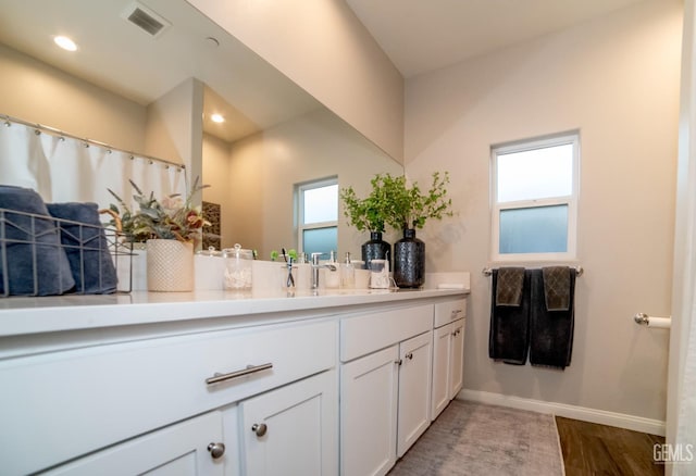 8414 Kowa St, Bakersfield, CA 93314 - full bathroom featuring vanity, wood finished floors, and recessed lighting