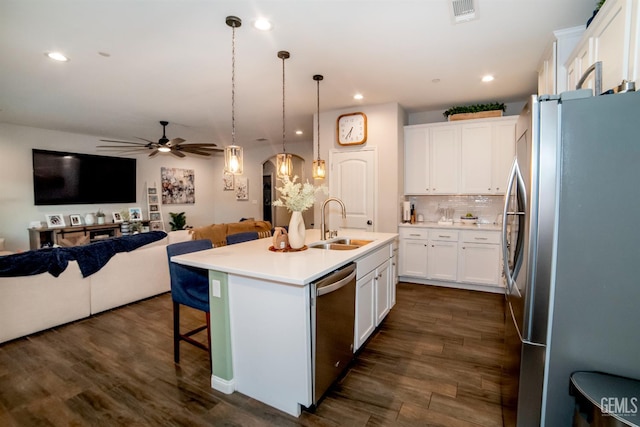 8414 Kowa St, Bakersfield, CA 93314 - kitchen featuring appliances with stainless steel finishes, open floor plan, a kitchen bar, white cabinetry, and recessed lighting