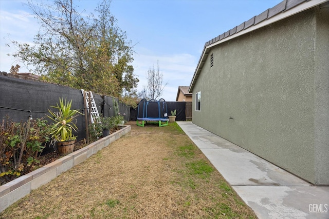 view of yard with a trampoline