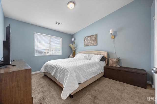 carpeted bedroom with vaulted ceiling