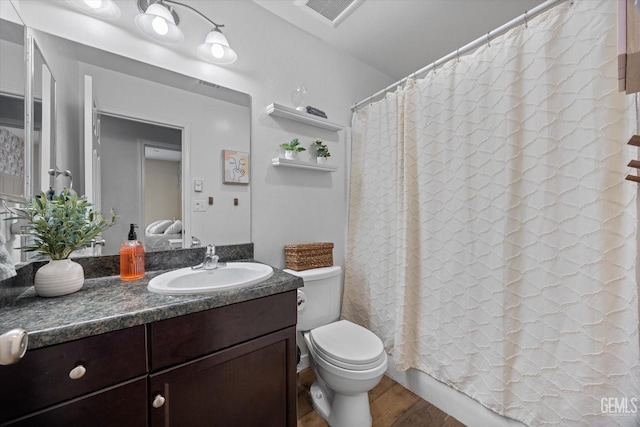 bathroom featuring hardwood / wood-style flooring, vanity, and toilet