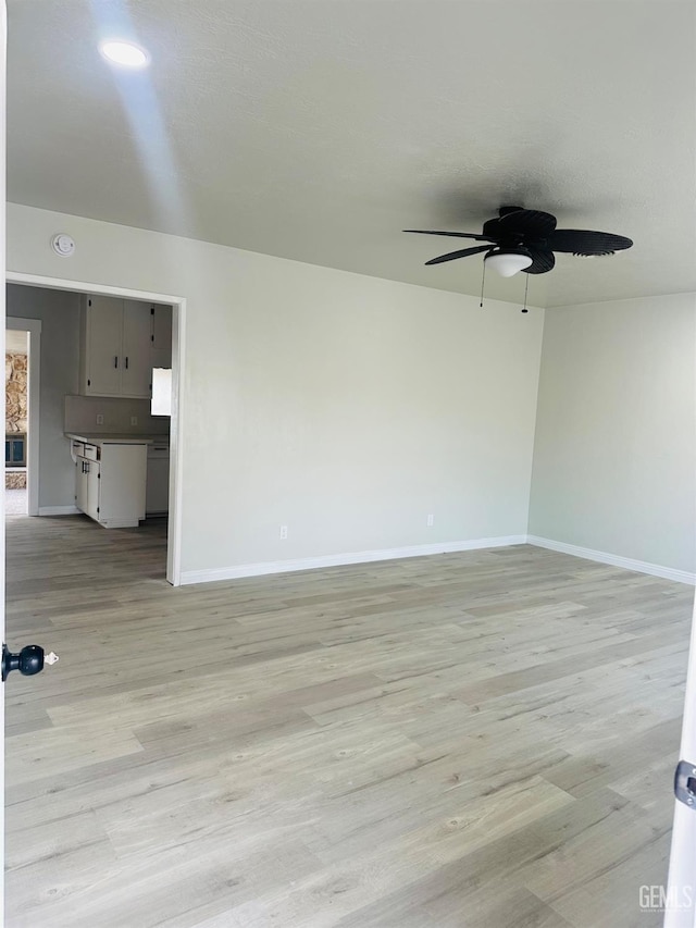 spare room featuring ceiling fan and light wood-type flooring