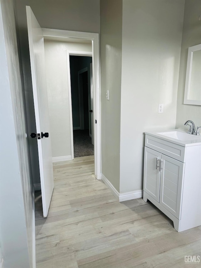 bathroom featuring hardwood / wood-style flooring and vanity