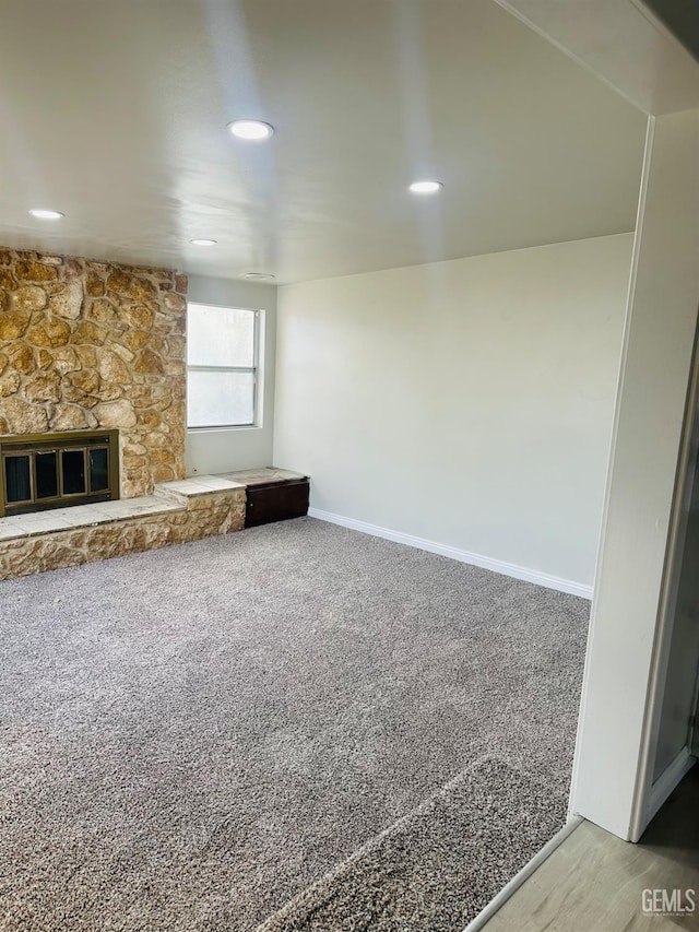 unfurnished living room with a fireplace and carpet flooring