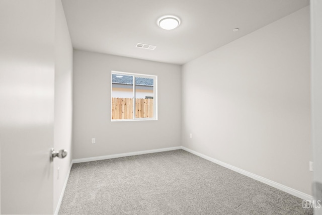 unfurnished room with carpet flooring, baseboards, and visible vents