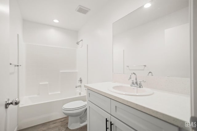 full bath with vanity, toilet, recessed lighting, wood finished floors, and shower / bathing tub combination
