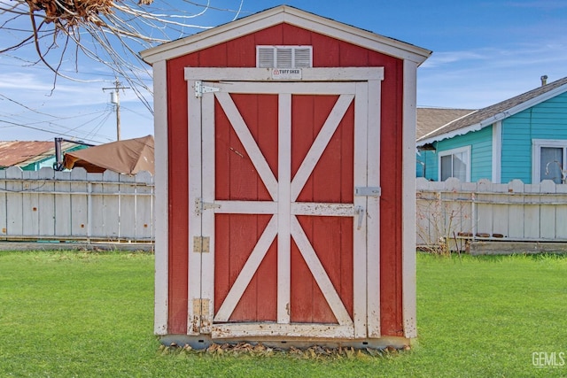 view of outbuilding with a yard