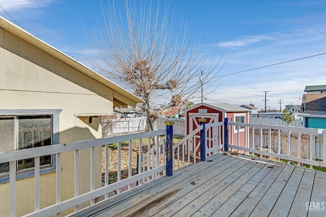 wooden terrace featuring a storage shed