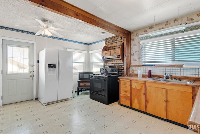 kitchen featuring sink, ceiling fan, white refrigerator with ice dispenser, gas range oven, and beamed ceiling