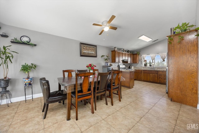 dining area featuring visible vents, ceiling fan, baseboards, vaulted ceiling, and light tile patterned flooring