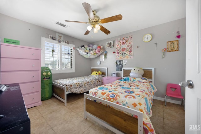 bedroom with light tile patterned floors, baseboards, visible vents, and ceiling fan