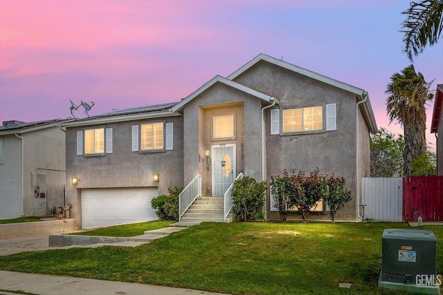 view of front facade featuring stucco siding, solar panels, a front yard, and fence