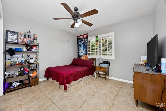 bedroom featuring light tile patterned flooring, ceiling fan, and baseboards