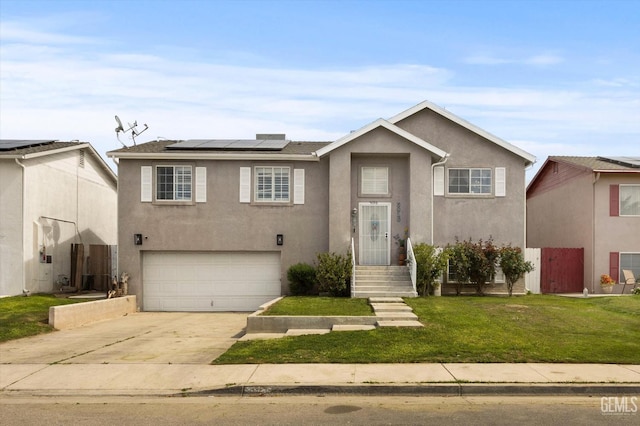 view of front of house with concrete driveway, a front yard, roof mounted solar panels, and stucco siding