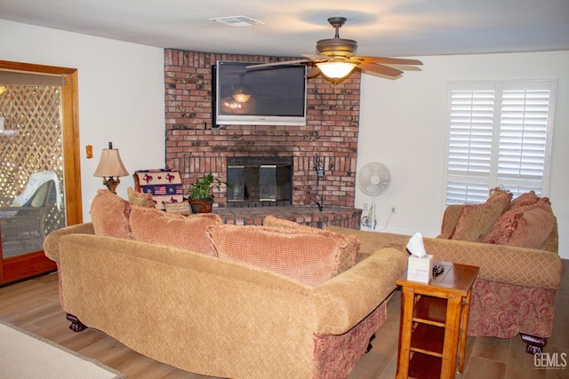 1301 Charterten Ave, Bakersfield, CA 93307 - living room featuring ceiling fan, wood finished floors, and a brick fireplace
