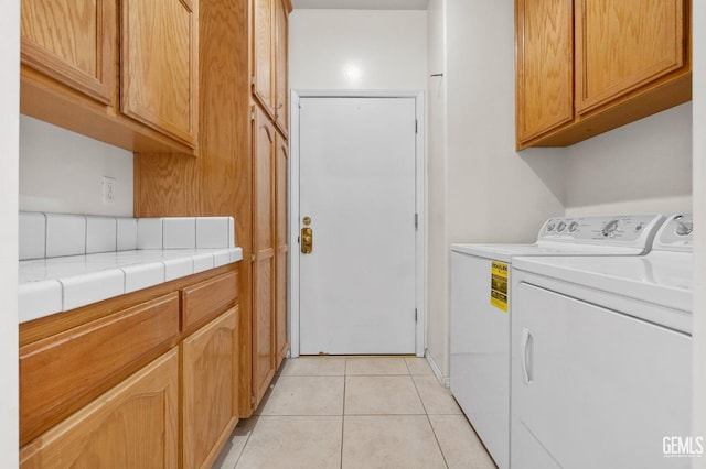 4216 Lightning Ct, Bakersfield, CA 93312 - washroom featuring washing machine and dryer, cabinet space, and light tile patterned floors