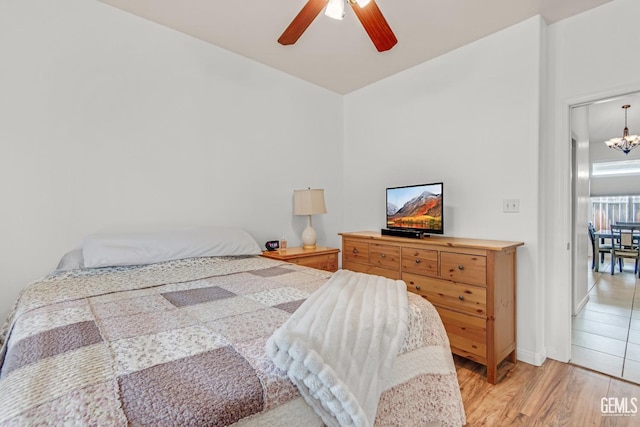 4216 Lightning Ct, Bakersfield, CA 93312 - bedroom with a chandelier, light wood-type flooring, and ceiling fan