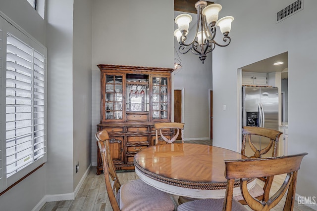 9604 Lea Oak Rd, Bakersfield, CA 93311 - dining space with a high ceiling, a chandelier, and light wood finished floors