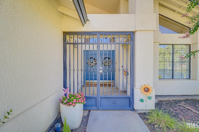 9604 Lea Oak Rd, Bakersfield, CA 93311 - doorway to property with stucco siding and a gate