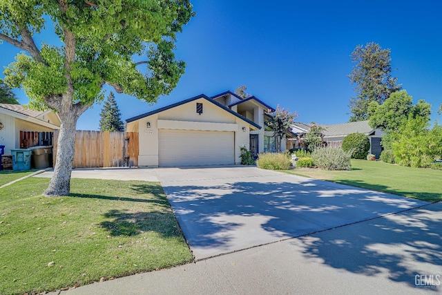 9604 Lea Oak Rd, Bakersfield, CA 93311 - view of front facade with stucco siding, driveway, and an attached garage