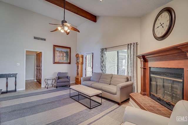 9604 Lea Oak Rd, Bakersfield, CA 93311 - living area featuring a glass covered fireplace, a ceiling fan, high vaulted ceiling, and beam ceiling