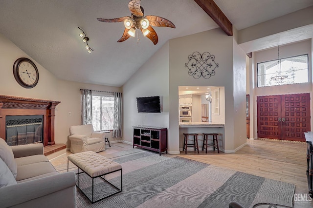 9604 Lea Oak Rd, Bakersfield, CA 93311 - living room featuring a ceiling fan, wood finished floors, high vaulted ceiling, a glass covered fireplace, and beamed ceiling
