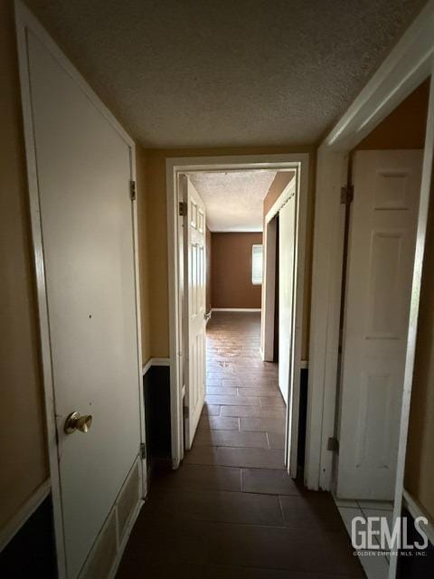 hallway with a textured ceiling