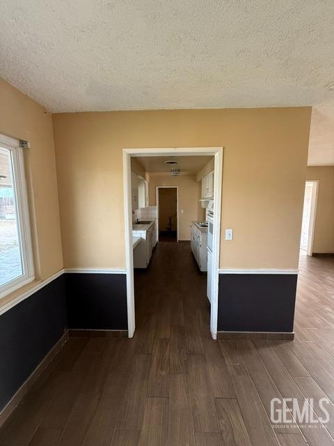 interior space with dark wood-type flooring and a textured ceiling