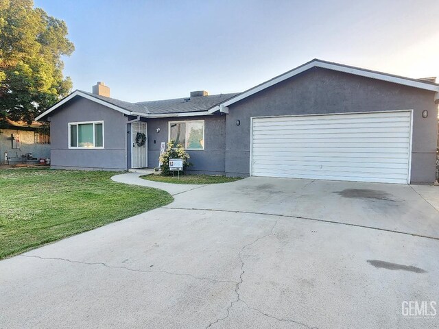 5812 Appletree Ln, Bakersfield, CA 93309 - ranch-style home featuring concrete driveway, an attached garage, a front yard, a chimney, and stucco siding