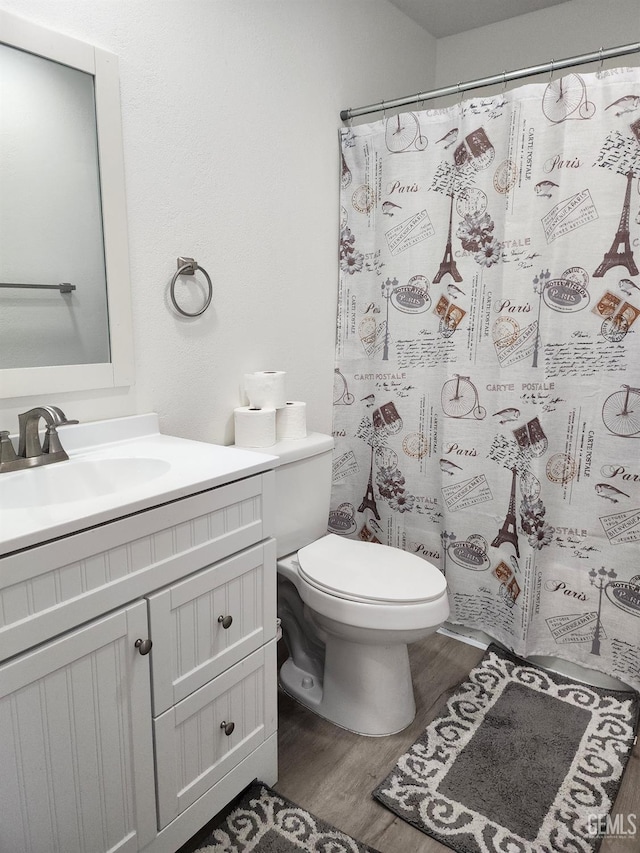 5812 Appletree Ln, Bakersfield, CA 93309 - full bath featuring vanity, toilet, a shower with shower curtain, and wood finished floors