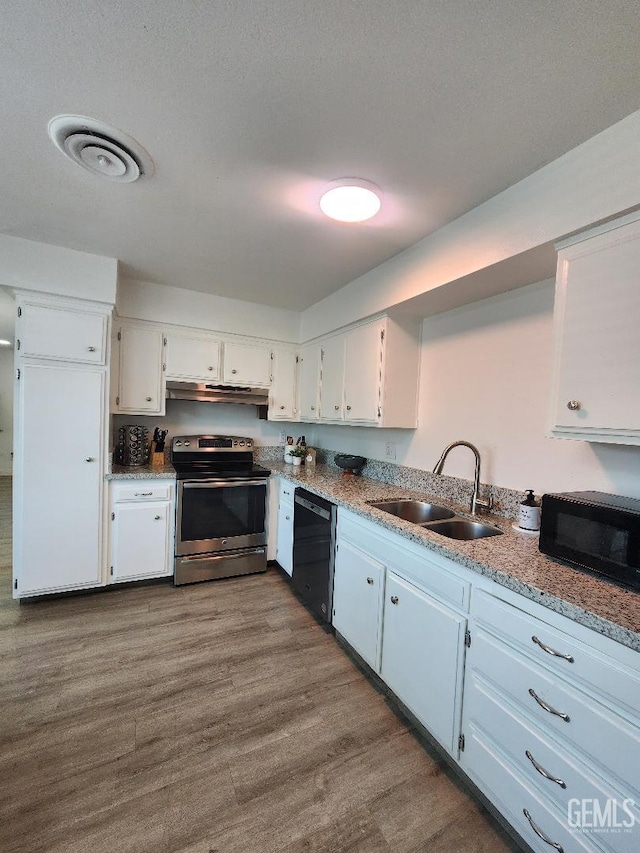 5812 Appletree Ln, Bakersfield, CA 93309 - kitchen with black appliances, white cabinetry, under cabinet range hood, and dark wood-type flooring