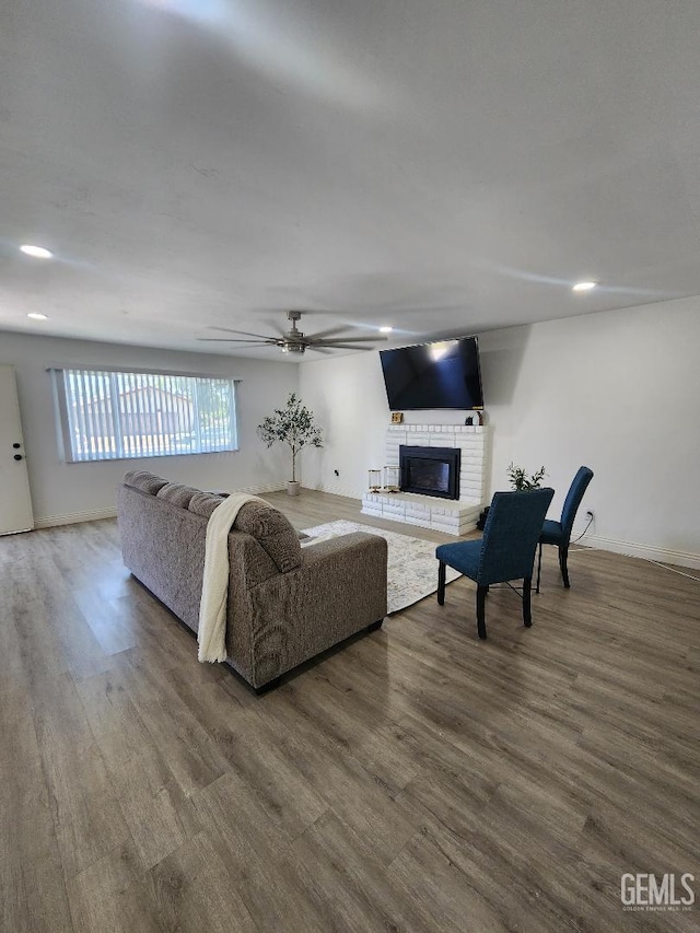 5812 Appletree Ln, Bakersfield, CA 93309 - living area featuring wood finished floors, a brick fireplace, ceiling fan, and recessed lighting