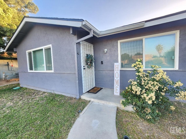 5812 Appletree Ln, Bakersfield, CA 93309 - entrance to property featuring stucco siding and a lawn