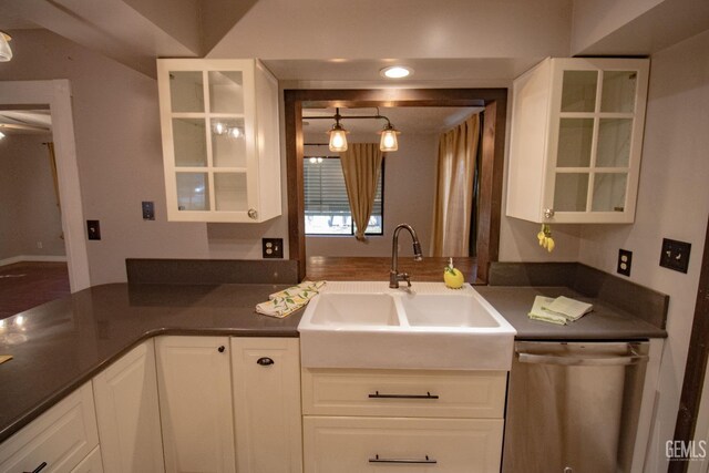 kitchen featuring appliances with stainless steel finishes, white cabinetry, baseboards, and wood finished floors