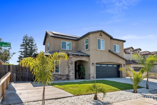 view of front facade featuring a front lawn, a garage, and solar panels