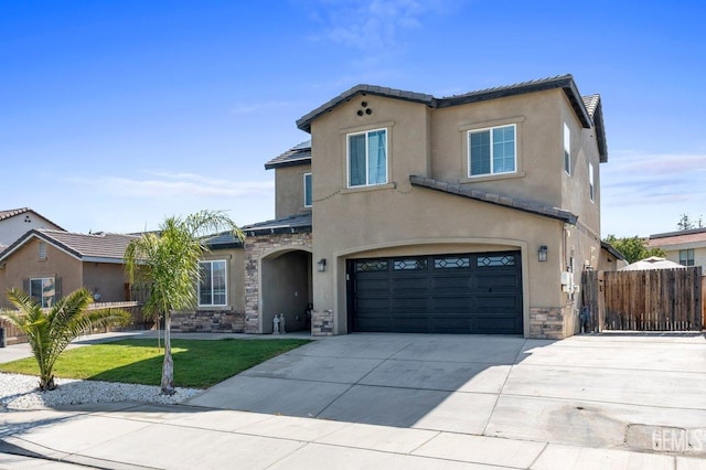 mediterranean / spanish-style home featuring a garage and a front lawn