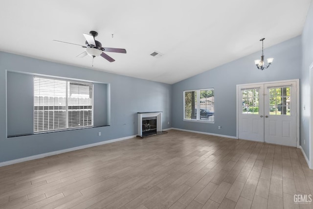 10415 Olympia Fields Dr, Bakersfield, CA 93312 - unfurnished living room featuring a glass covered fireplace, vaulted ceiling, wood finished floors, a chandelier, and a ceiling fan