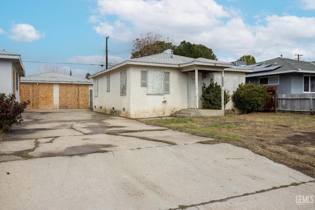 view of front of property with stucco siding and fence