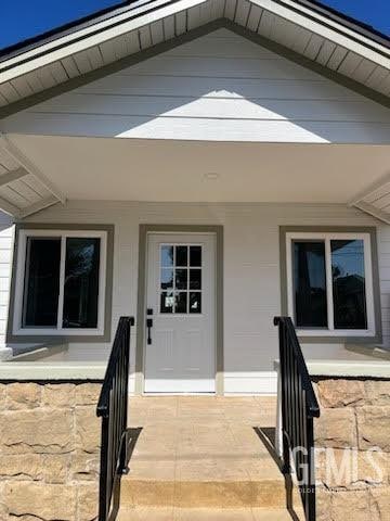 property entrance featuring covered porch