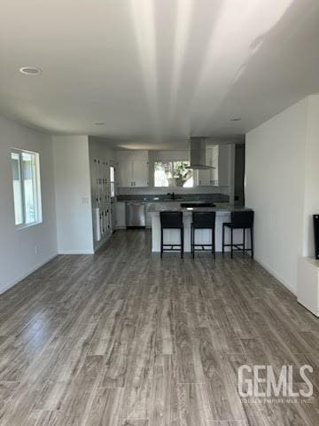 unfurnished living room with dark wood-type flooring