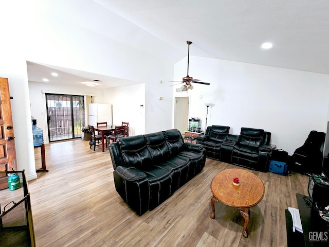 living room with ceiling fan, high vaulted ceiling, and light hardwood / wood-style flooring