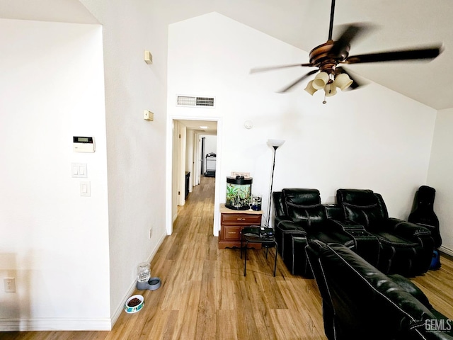 home theater with light hardwood / wood-style floors and ceiling fan