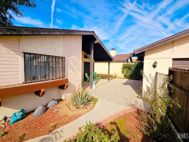 view of side of home with a patio