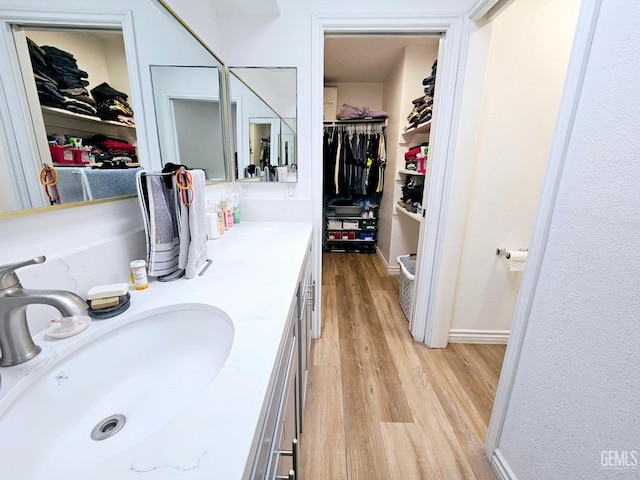 bathroom with vanity and wood-type flooring