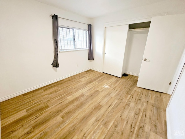 unfurnished bedroom featuring a closet and light hardwood / wood-style flooring