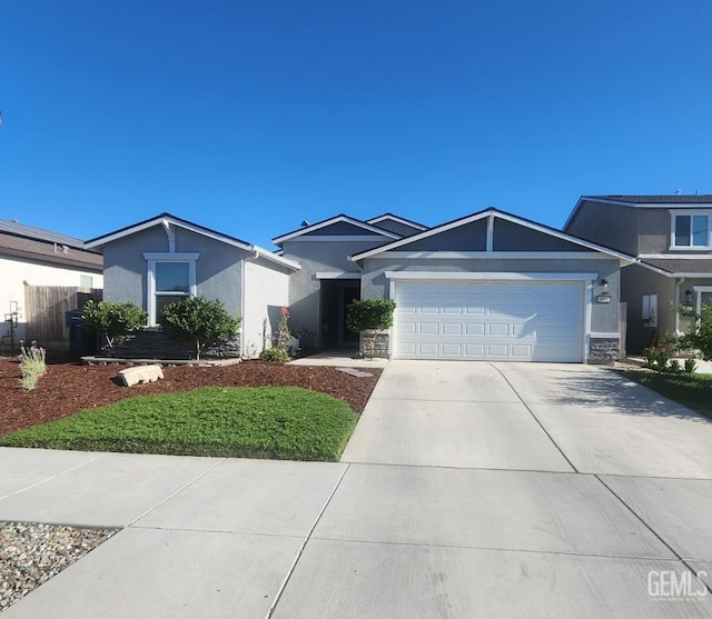 5911 Bogart Dr, Bakersfield, CA 93313 - ranch-style home featuring stucco siding, concrete driveway, a garage, and stone siding