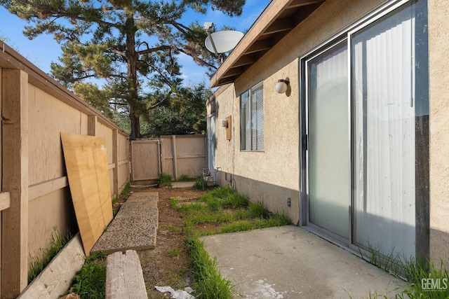 view of side of home with a patio