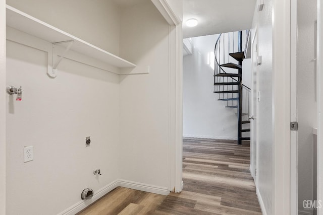 laundry room featuring wood-type flooring and hookup for a gas dryer