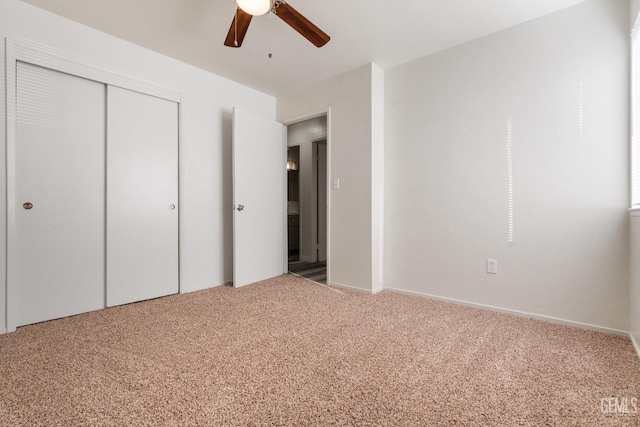 unfurnished bedroom with a closet, ceiling fan, and carpet